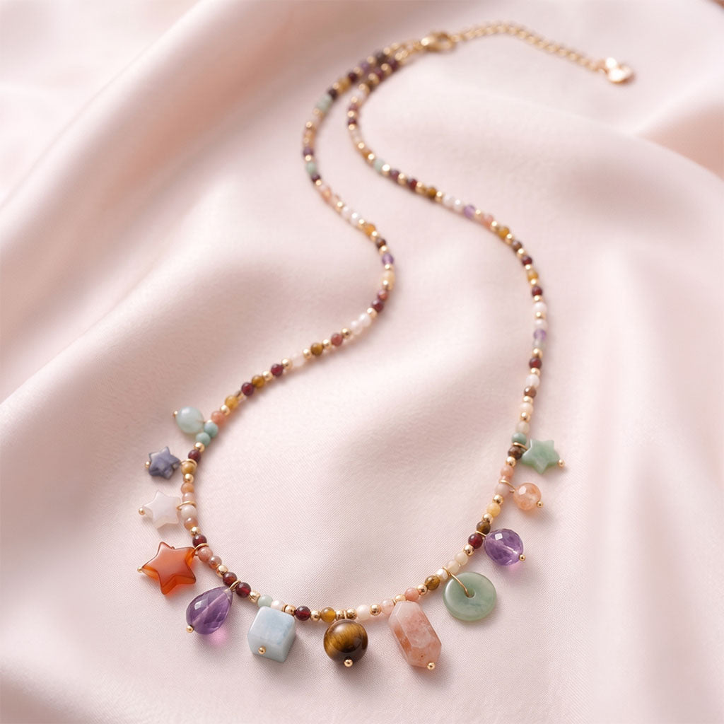 Celestial Crystal Charm Necklace is set on light-colored silk, showcasing its details.