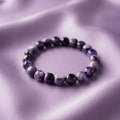 Charoite Energy Bracelet - Polished natural stones showcasing unique swirling patterns of purple and white luster