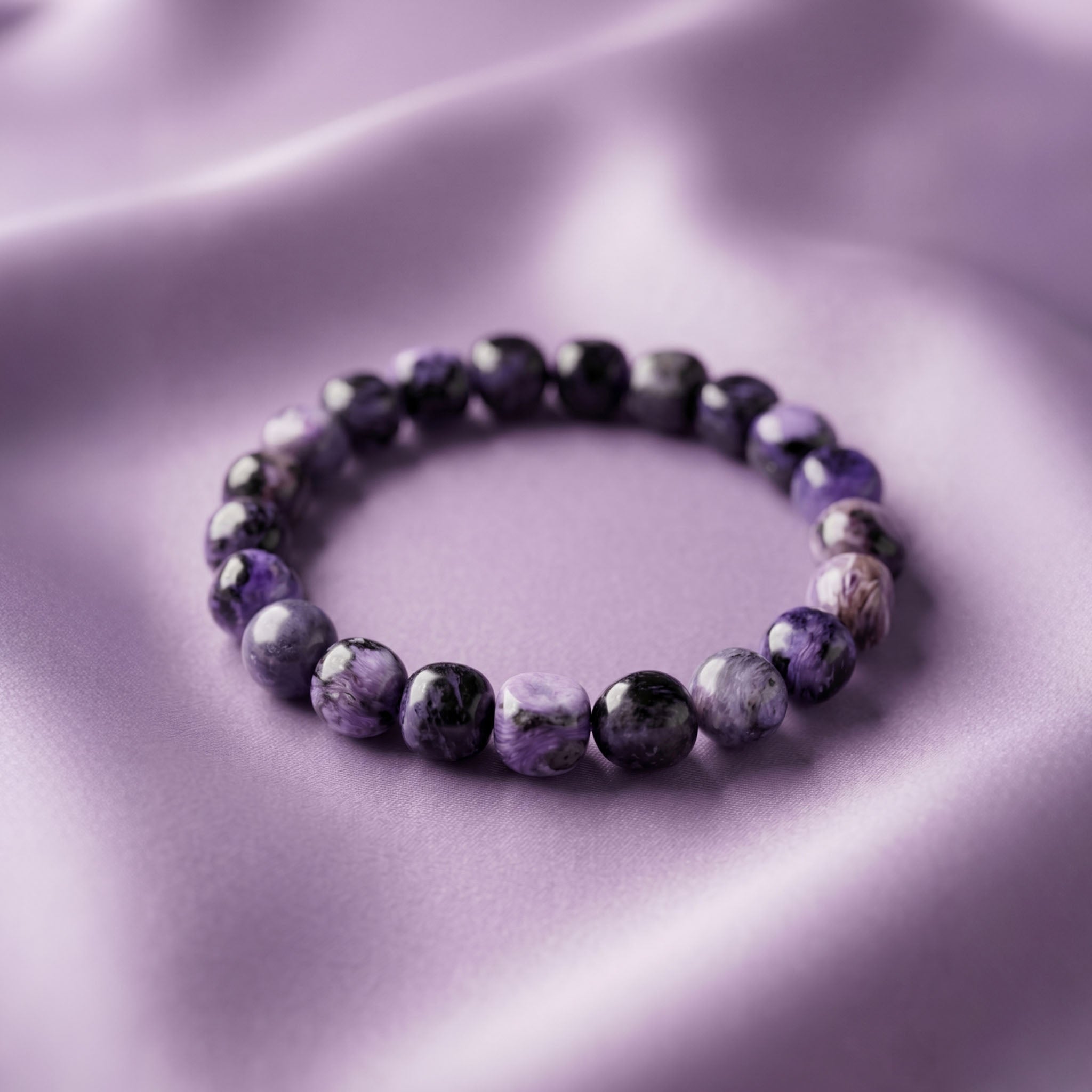 Charoite Energy Bracelet - Polished natural stones showcasing unique swirling patterns of purple and white luster