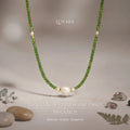 Diopside & Freshwater Pearl Energy Necklace displayed in a minimalist natural setting