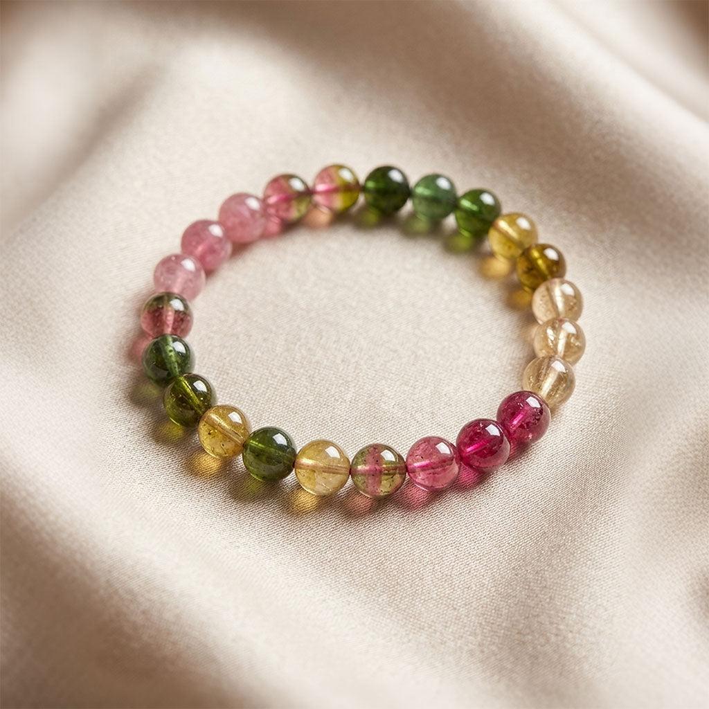 Details of the tourmaline energy bracelet placed on gray silk