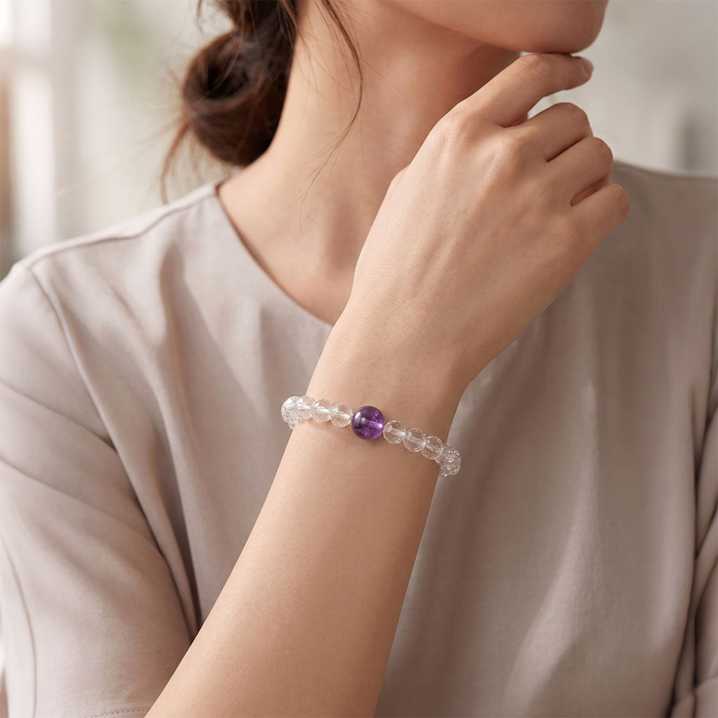 Minimalist lifestyle photo of Amethyst and Clear Quartz bracelet worn on wrist